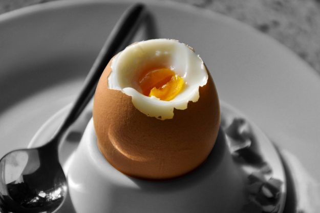 Cracked egg revealing soft yolk, symbolizing the right timing and strategic insights for successful M&A integration.