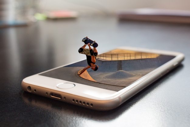 Skateboarder performing a trick emerging from a smartphone screen – visual metaphor for middle management time warp and the blog ‘Six Sigma Thinking in the TikTok World.’