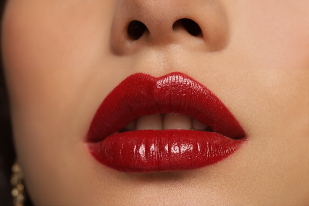 Close-up of bold red lips representing ‘lip service’ — visual metaphor for “Lip Service vs. Lift-Off: How Passive Workstream Leads Derail M&A Value.”