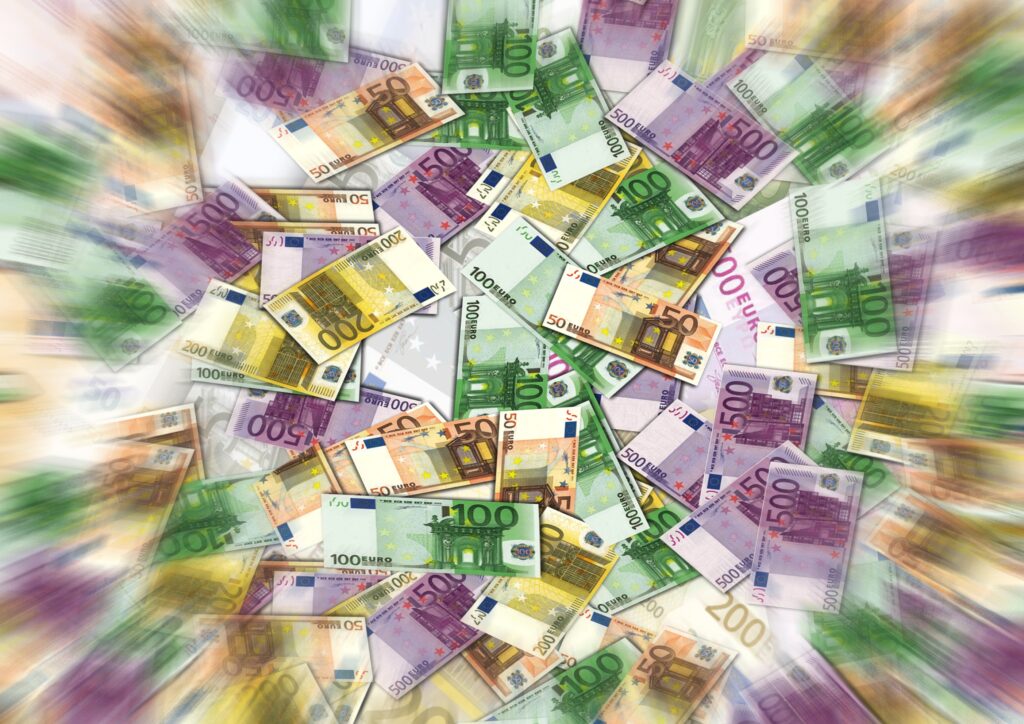 Euro banknotes of every denomination scattered and radiating outward — cover image for 'Cash Is Still King: The Financial Reality of the Buy-and-Build Journey.'