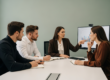 A leader presenting growth data to colleagues around a conference table, driving strategic discussion — Buy-and-Build's Scaling Gap: Critical Dependence on HR Evolution?
