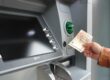 Growth Doesn’t Fund Itself: What Scaling Costs an Owner-Led Business – hand holding 50-euro notes beside an ATM
